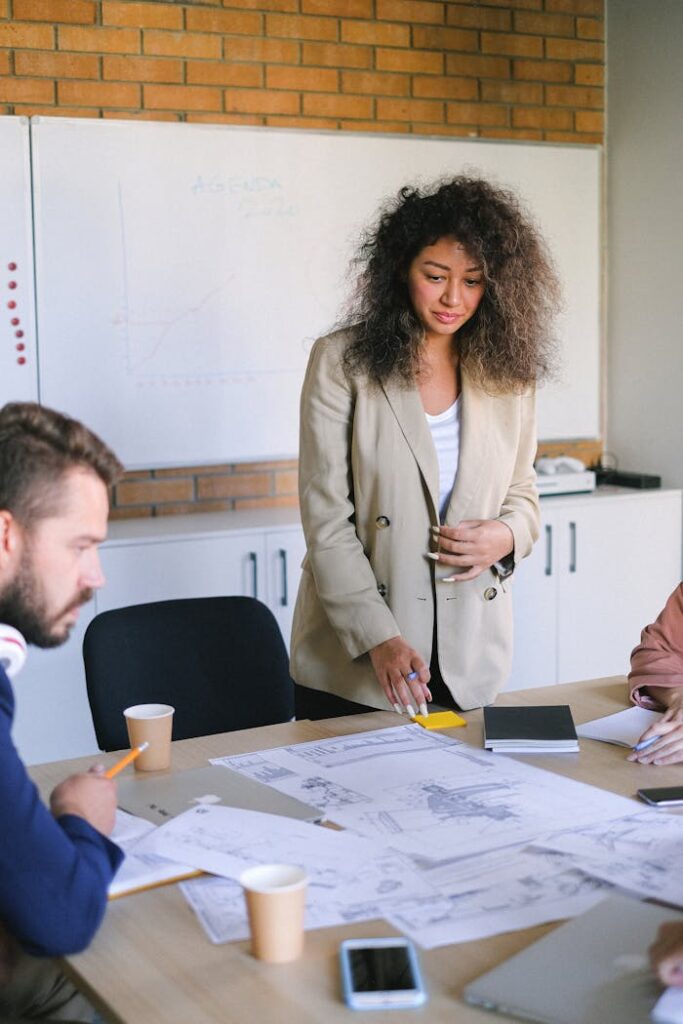 Professionals engaging in a collaborative business meeting with charts and documents.